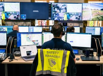Safety manager acting as dispatcher, monitoring the field team from multiple computer screens.
