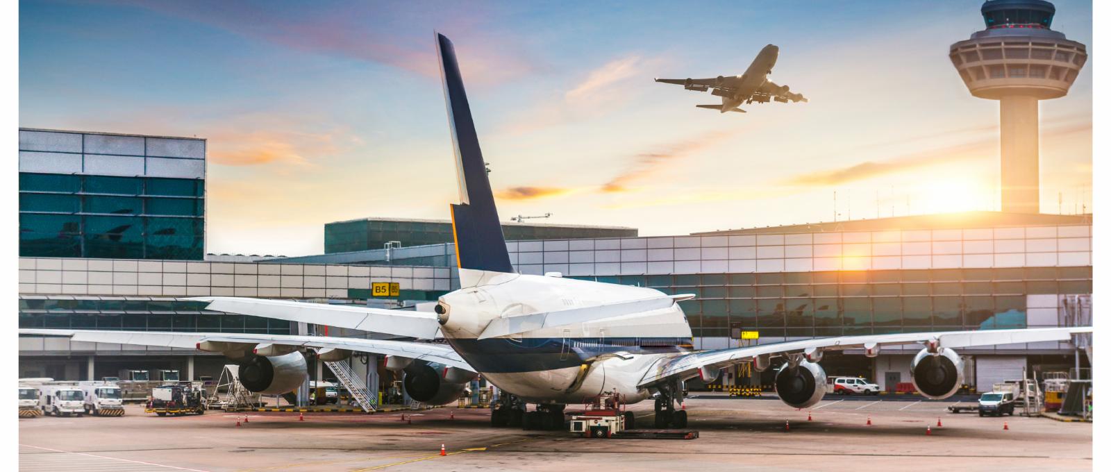 Workers at an airport wearing earmuffs with Push to Talk
