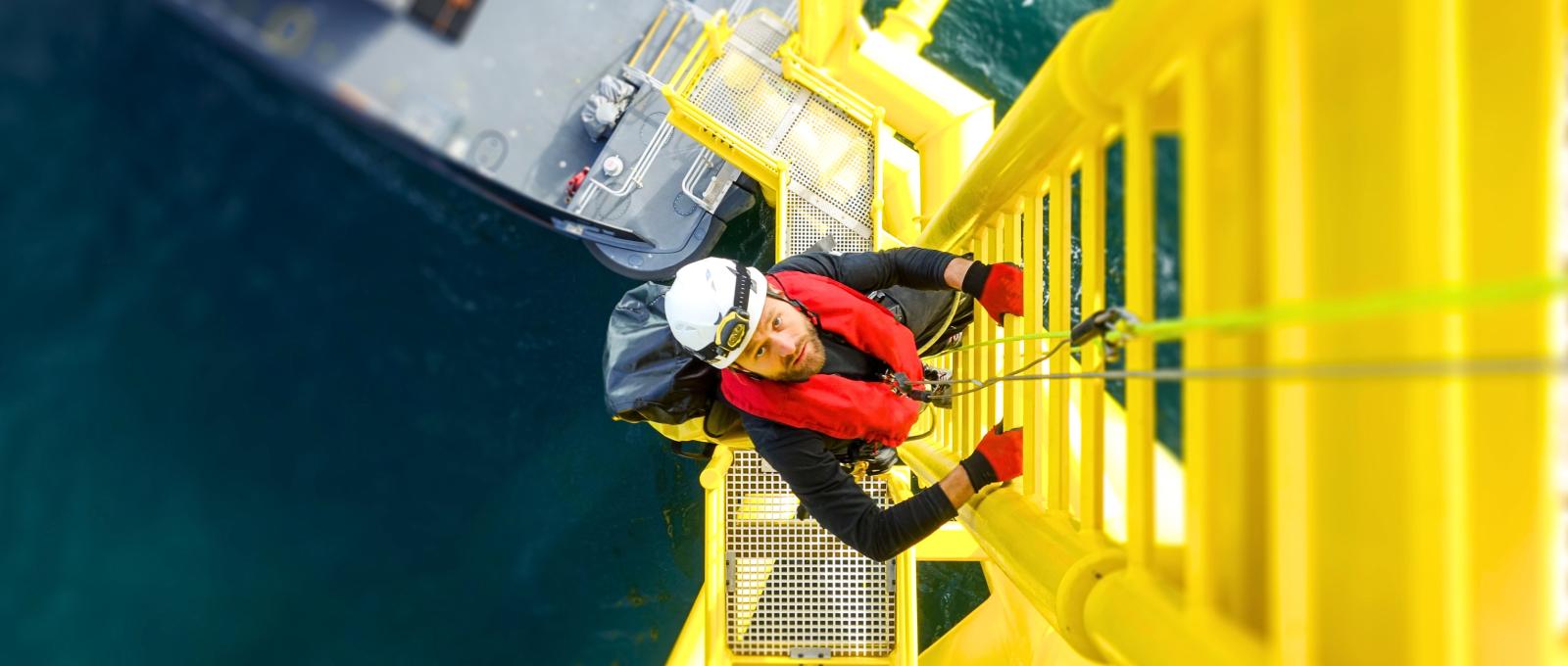 Offshore workers climbing on a oil platform