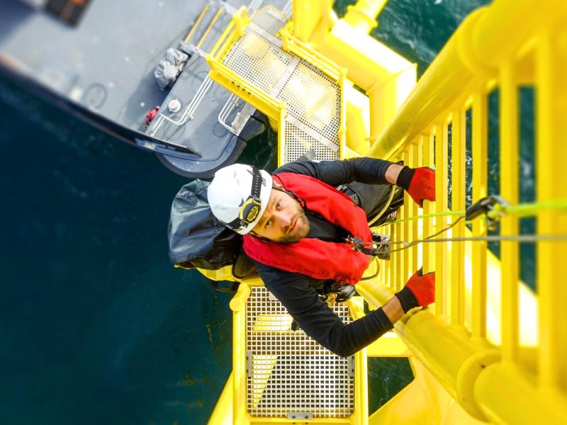 Offshore workers climbing on a oil platform