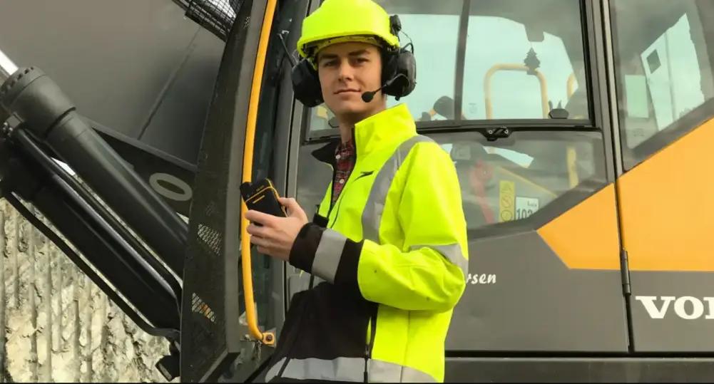Construction workers with Push to Talk two way radio and earmuffs with push to talk