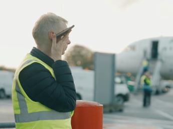 Airport worker talking in two way radio app from grouptalk