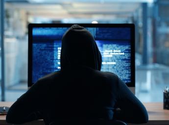 Cybersecurity threat: hacker using computer.