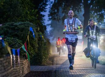 A man running at Roparun race in the dark