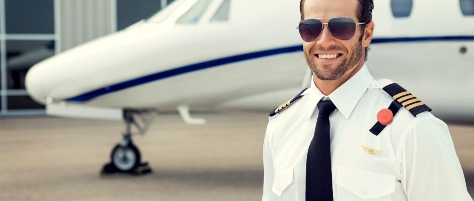 the aircraft captain stands in front of an aircraft