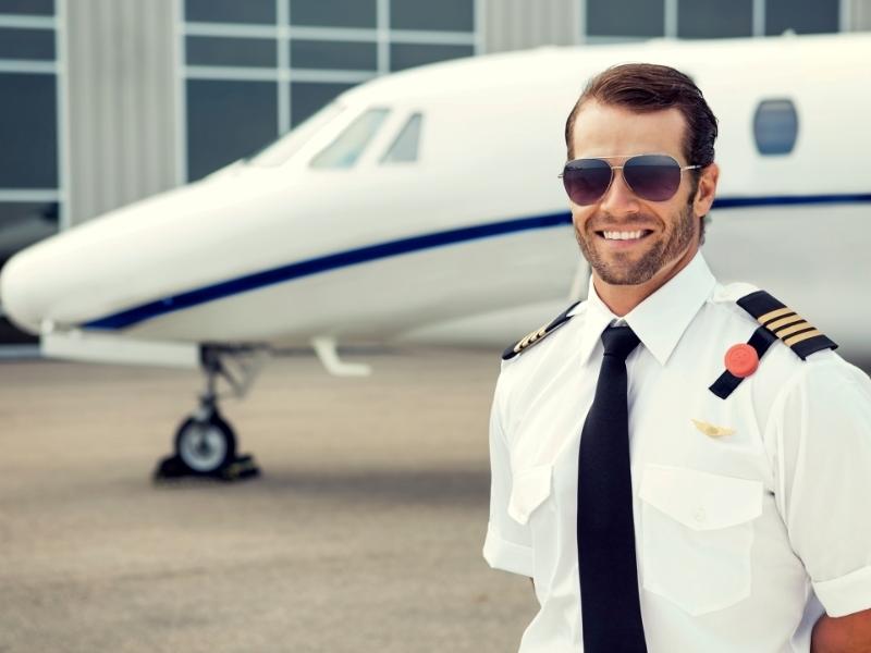the aircraft captain stands in front of an aircraft
