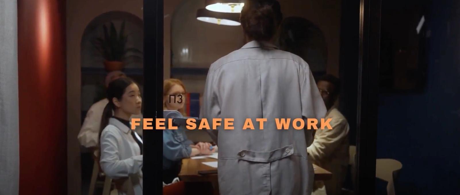 A room with people with the text feel safe at work