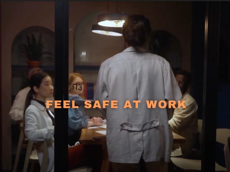 A room with people with the text feel safe at work