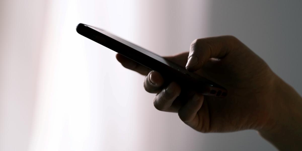 GroupTalk two way radio walkie talkie that a person presses on