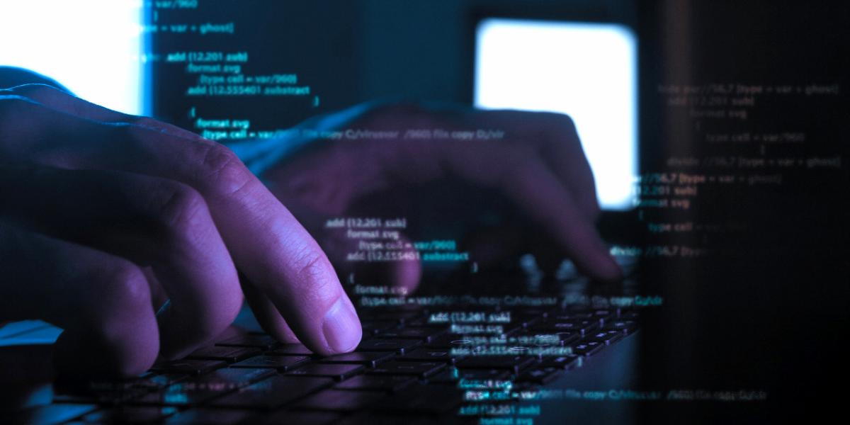 Person typing on a computer in GroupTalk web admin