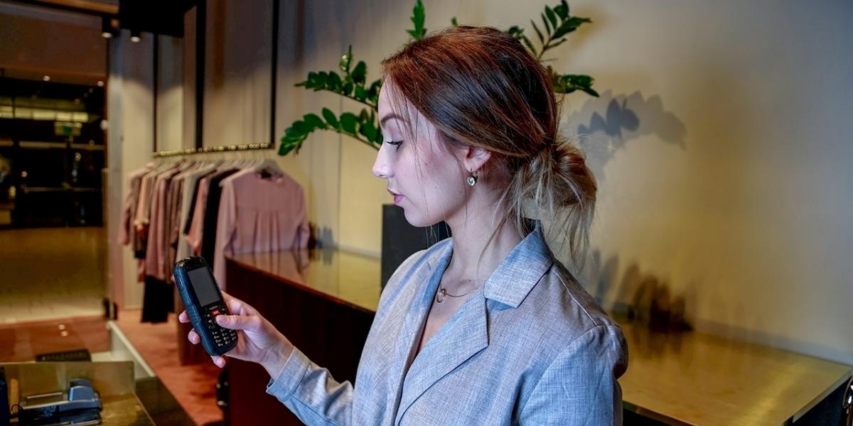 Female lone worker with staff alarm for lone work in store