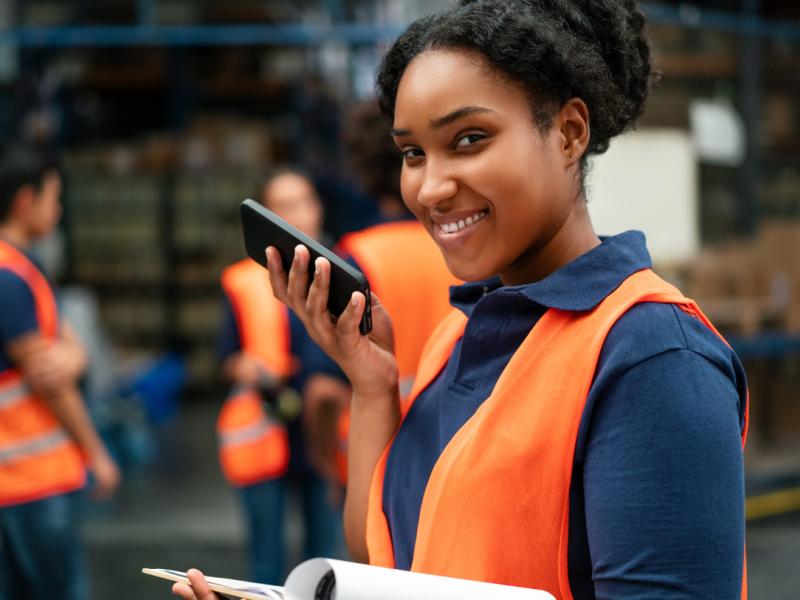 A person stands on a roof of a building and tunes an old two way radio system.